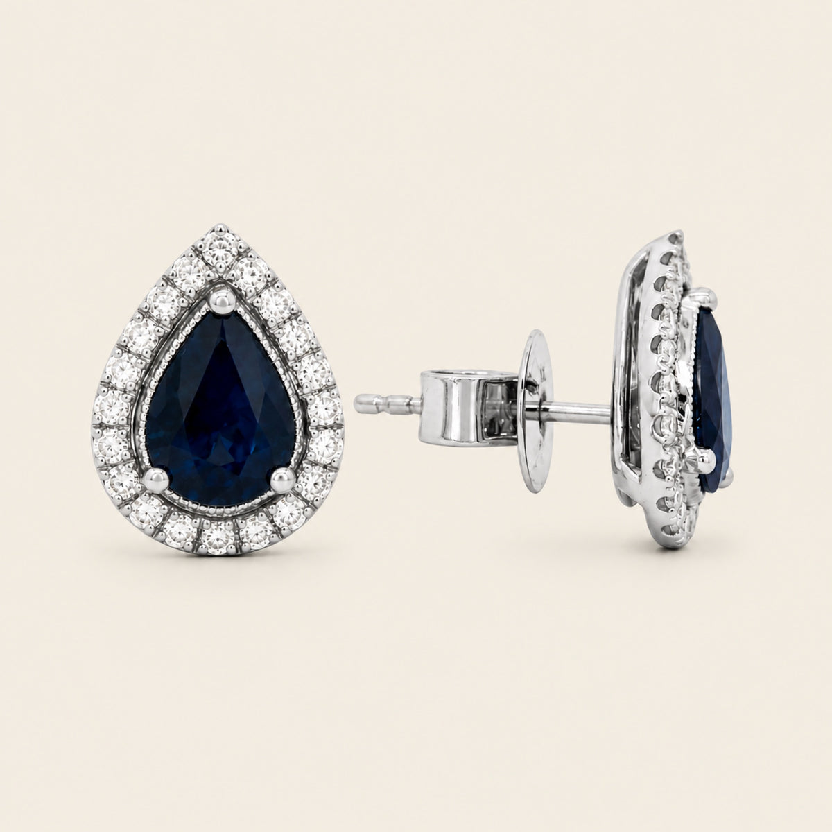 Aretes de Oro Blanco 18k con Zafiro Pera y Halo de Diamantes